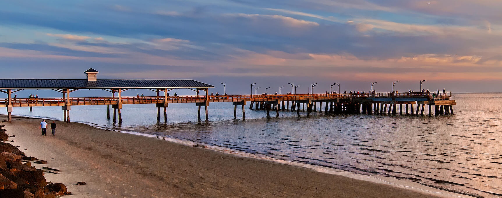 sunset on the beach with pier in background
