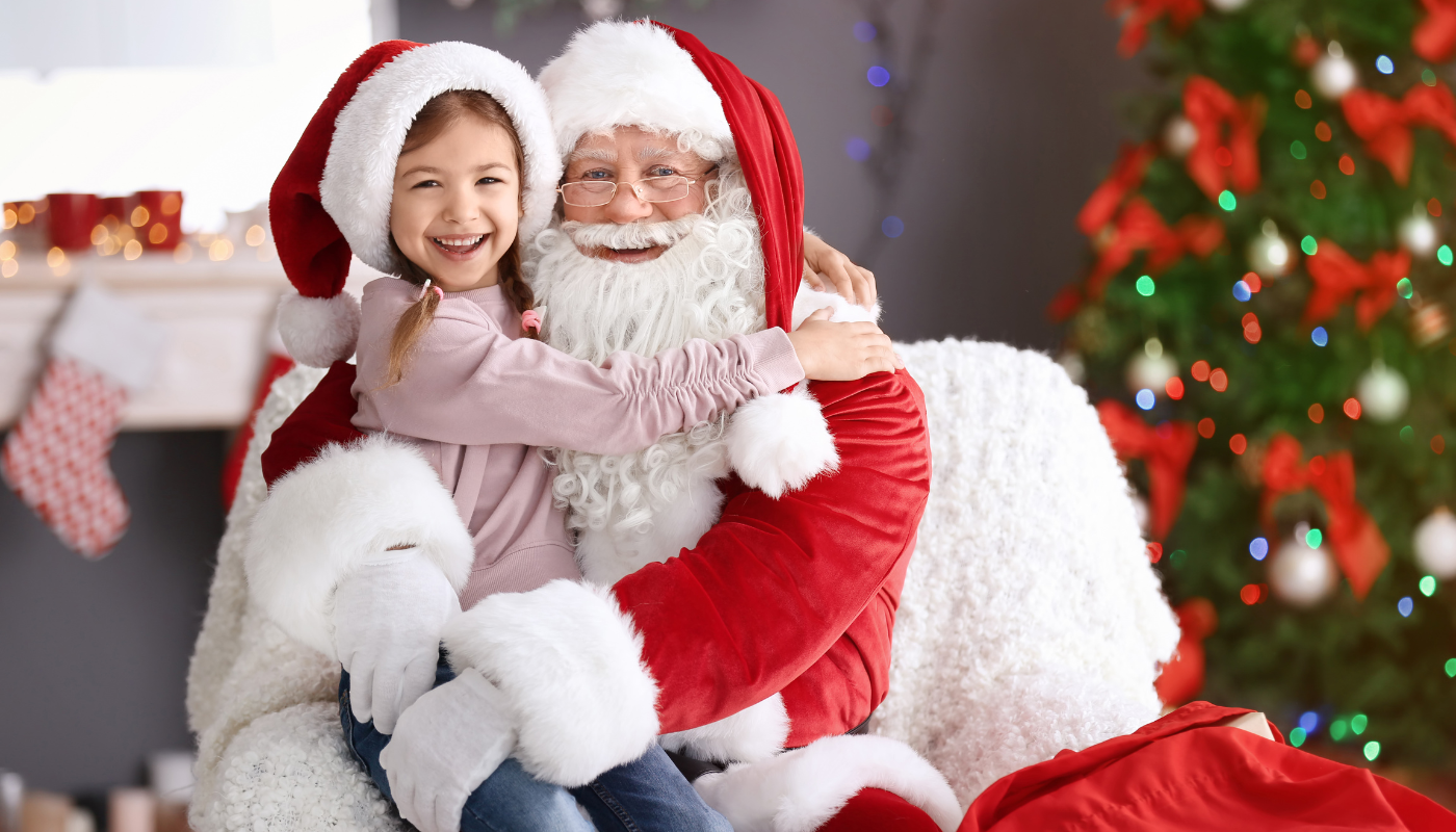 little girl on santa's lap at golden isles holiday event