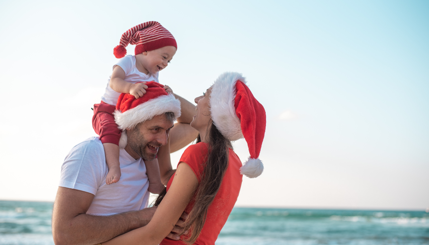 family in santa hats on a st simons island beach