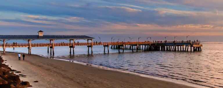 sunset on the beach with st simons pier in background